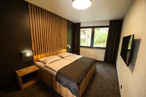 Ένα ή περισσότερα κρεβάτια σε δωμάτιο στο Hotel Kras