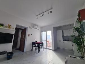 een woonkamer met een tafel en een eetkamer bij Top Floor with terrace and 5 mins walk to centre in Marsaskala
