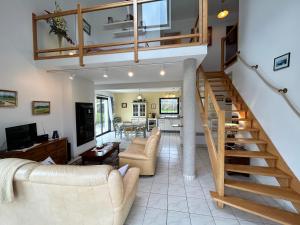a living room with a staircase and a living room at 305 - Belle maison à deux pas de l'Anse du Croc in Fréhel