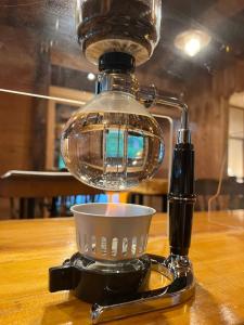 a coffee maker with a cup on a table at irodori in Matsumoto