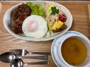 a table with two plates of food and a cup of soup at irodori in Matsumoto
