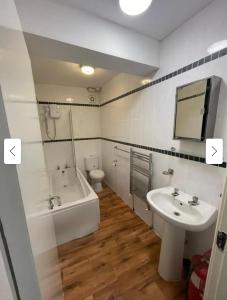 a bathroom with a sink and a tub and a toilet at 29 ASHBURTON STREET in Stoke on Trent