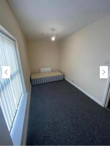 a small room with a bed and a window at 29 ASHBURTON STREET in Stoke on Trent
