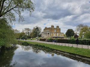 a building next to a river in front of a building at Vibrant 3BR flat near Finsbury Park in London