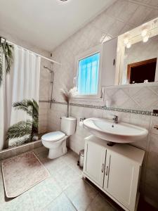 a bathroom with a sink and a toilet and a shower at Casa Elena in Sant Pere Pescador