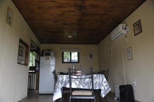 a dining room with a table and a refrigerator at Cabañas La Carmela Piedras B Potrerillos in Potrerillos