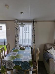 a dining room with a table and a couch at NV 1221 - Beach Resort Nieuwvliet Bad in Nieuwvliet