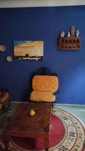 a blue room with a chair and a table at j appartement in Essaouira