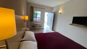 a hotel room with a bed and a television at Nova Hotel in Cadereyta Jim&eacute;nez