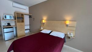 - une chambre avec un lit et une couverture rouge dans l'établissement Nova Hotel, à Cadereyta Jiménez