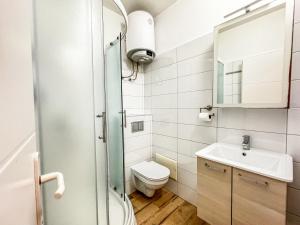 a small bathroom with a toilet and a sink at Apartments Habek 2 in Vrboska