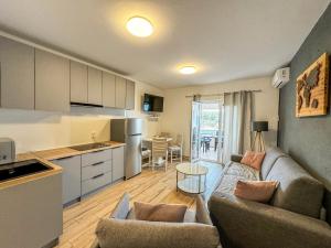 a living room with a couch and a kitchen at Apartments Habek 2 in Vrboska +30 photos