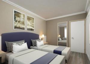 a bedroom with two beds and a window at L'ancora Beach Hotel in Kemer