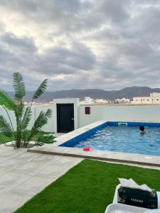 a swimming pool on the roof of a house at فيلا صلاله بالم salalah palm villa in Salalah