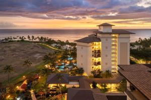 an aerial view of a hotel and the ocean at sunset at Ko Olina Beach Villas O1402 in Kapolei