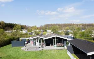 a house with a large deck with a roof at 3 Bedroom Stunning Home In Svendborg in Svendborg