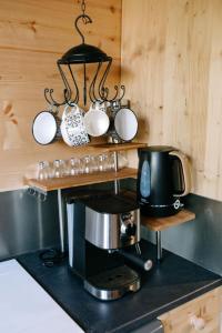 a kitchen with a counter top with a coffee maker at Charming Tiny House in LʼIsle-sur-la-Sorgue