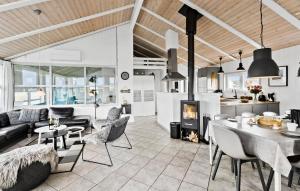 a living room with a couch and a table at Amazing Home In Løkken With Sauna in Løkken