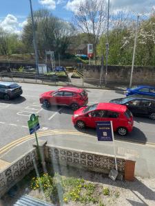 a group of cars parked in a parking lot at Manchester Stay in Farnworth