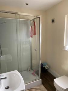 a bathroom with a shower and a sink at Manchester Stay in Farnworth