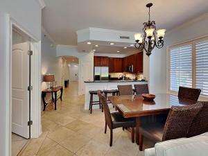 a dining room and kitchen with a table and chairs at Adagio 101f in Santa Rosa Beach