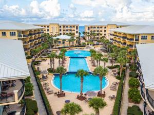 an aerial view of a resort with a pool and palm trees at Adagio 101f in Santa Rosa Beach