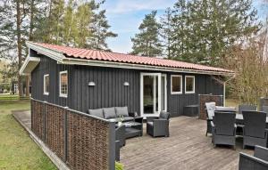 a black tiny house on a wooden deck at 4 Bedroom Pet Friendly Home In Vggerlse in Bøtø By