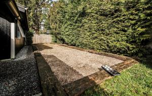 a remote control laying on the grass next to a house at Four-Bedroom Holiday Home In Vaggerlose in Marielyst +11 photos