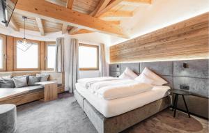 a bedroom with a large bed and a couch at 2 Bedroom Awesome Apartment In St, Anton in Sankt Anton am Arlberg