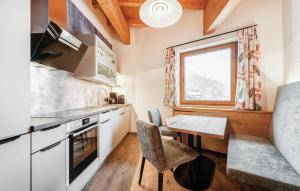 a kitchen with a table and a window at 2 Bedroom Awesome Apartment In St, Anton in Sankt Anton am Arlberg