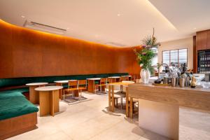 a restaurant with wooden walls and wooden tables and chairs at Saan Hotel Sathorn in Bangkok
