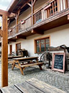 a patio with a table and a chalkboard in front of a building at Mohelenský dvůr in Mohelno