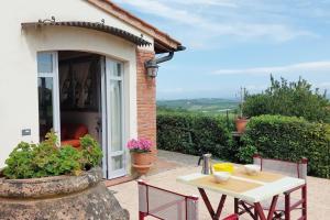 a table and chairs in front of a house at Castello di Fulignano Leonardo apartment ground floor in San Gimignano