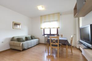 a living room with a table and a couch at Apartments Rajkovic in Labin