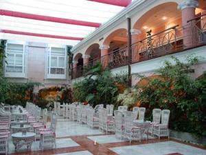 a row of white chairs and tables in a building at Hotel Begoña Park in Gijón