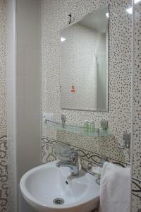 a bathroom with a sink and a mirror at Hotel ART PALACE TASHKENT in Chilanzar