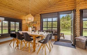 a wooden dining room with a wooden table and chairs at Amazing Home In Fjerritslev With Wifi in Fjerritslev