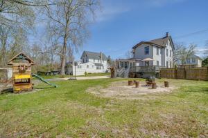 a yard with a playground and a house at Family-Friendly Mays Landing Home Near The Cove! in Gravelly Run