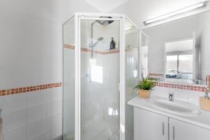 Un baño blanco con ducha y lavabo. en Modern Scarborough Townhouse, en Perth 36 fotos más