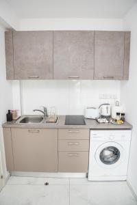 a kitchen with a sink and a washing machine at Quattro City Center Ap 501B in Larnaka