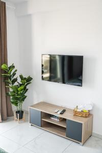 a living room with a tv on a white wall at Quattro City Center Ap 501B in Larnaka