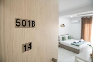 a room with a bed and a door with the numbers at Quattro City Center Ap 501B in Larnaka