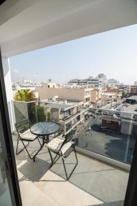 a patio with a table and chairs on a balcony at Quattro City Center Ap 501B in Larnaka