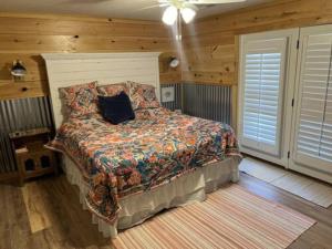 a bedroom with a bed with a pillow on it at Current River Getaway in Van Buren