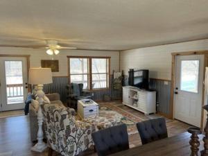 a living room with a couch and a tv at Current River Getaway in Van Buren