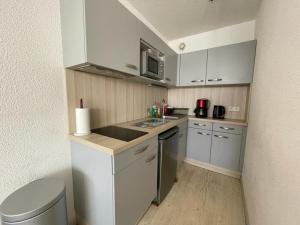a small kitchen with a sink and a microwave at Studio Capbreton, 1 pièce, 4 personnes - FR-1-413-134 in Capbreton