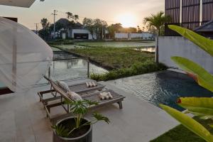 a patio with a bench and a swimming pool at Om Cemagi Beach Villa Canggu in Canggu +36 photos