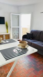 a living room with a table and a couch at Studio Saint-Cyprien Port in Saint-Cyprien