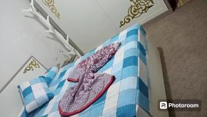 a pair of shoes sitting on top of a bed at Sand Castle Villa Azha - 2 bedrooms - Next Tanoak Hotel in Ain Sokhna
