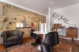 a living room with a table and two chairs at Oporto Chic & Cozy Studio Apartments in Porto